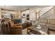 Inviting living room and kitchen with hardwood floors, modern furnishings, and stainless steel appliances at 11925 Piney Glade Rd, Noblesville, IN 46060