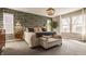 Spacious main bedroom with a luxurious king-sized bed, elegant chandelier, and abundant natural light at 11925 Piney Glade Rd, Noblesville, IN 46060