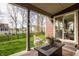 Covered patio with outdoor seating overlooking the fenced backyard and lush lawn at 11925 Piney Glade Rd, Noblesville, IN 46060