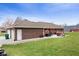 Spacious backyard shows off brick house and a large grass lawn at 12129 N Cedarview Dr, Mooresville, IN 46158