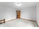 Empty bedroom with a neutral color palette, carpeted floors, and a wooden door at 12129 N Cedarview Dr, Mooresville, IN 46158