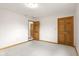 Spacious carpeted bedroom with natural wood trim and multiple closet doors at 12129 N Cedarview Dr, Mooresville, IN 46158