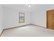 Bright, empty bedroom featuring neutral carpeting and a window overlooking the yard at 12129 N Cedarview Dr, Mooresville, IN 46158