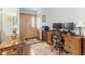 Inviting entryway with wood-look floors, a wood door, and a functional office space at 12129 N Cedarview Dr, Mooresville, IN 46158
