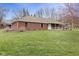 Quaint brick home with a cozy front porch and a spacious lawn, perfect for outdoor activities at 12129 N Cedarview Dr, Mooresville, IN 46158