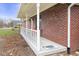 Close up of the home's inviting front porch, showcasing brick facade and school bus at 12129 N Cedarview Dr, Mooresville, IN 46158