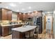 Well-appointed kitchen with granite countertops, an island with seating, and dark wood cabinetry at 12129 N Cedarview Dr, Mooresville, IN 46158