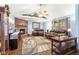 Inviting living room with brick fireplace, ceiling fan, and plush leather furniture at 12129 N Cedarview Dr, Mooresville, IN 46158