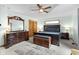 Spacious bedroom with elegant dark wood furniture and a stylish ceiling fan with overhead lighting at 12129 N Cedarview Dr, Mooresville, IN 46158