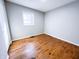 Bright bedroom with hardwood floors and a large window for natural light at 1246 Mcdougal St, Indianapolis, IN 46203