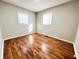 Cozy bedroom with hardwood floors and two windows for natural light at 1246 Mcdougal St, Indianapolis, IN 46203