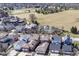 An aerial view of a suburban neighborhood with houses, trees, and a grassy field nearby at 12569 Branford St, Carmel, IN 46032
