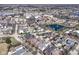 An overhead shot of a town with a pond, businesses, and a mix of house styles at 12569 Branford St, Carmel, IN 46032