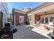 A welcoming backyard featuring a brick home with patio and landscaped concrete at 12569 Branford St, Carmel, IN 46032