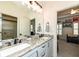 Bathroom featuring double sinks, granite countertops, and modern fixtures at 12569 Branford St, Carmel, IN 46032
