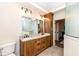 Bathroom with double sinks, wood cabinets, and a glass shower, perfect for relaxation at 12569 Branford St, Carmel, IN 46032