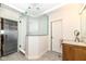 Modern bathroom with a standing shower, bright lighting and neutral-toned tile flooring at 12569 Branford St, Carmel, IN 46032