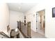 Upstairs hallway with access to multiple rooms, a view to downstairs, and neutral decor at 12569 Branford St, Carmel, IN 46032
