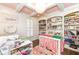 Bright hobby room featuring custom shelving, a large crafting table, and ample natural light at 12569 Branford St, Carmel, IN 46032