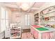 Bright hobby room featuring custom shelving, a large crafting table, and ample natural light at 12569 Branford St, Carmel, IN 46032