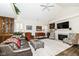 Cozy living room featuring a fireplace, plush rug, and comfortable seating arrangement at 12569 Branford St, Carmel, IN 46032