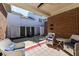 Covered patio area with comfortable seating and views of the backyard's privacy fence at 12569 Branford St, Carmel, IN 46032
