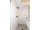 Modern shower featuring sleek white subway tile and herringbone patterned tile flooring at 12569 Branford St, Carmel, IN 46032