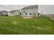 Large backyard featuring a well-maintained lawn and a circular concrete patio area at 13820 N Honey Creek Dr, Camby, IN 46113