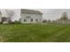 Spacious backyard with a freshly cut lawn, patio, and ample space for outdoor activities at 13820 N Honey Creek Dr, Camby, IN 46113
