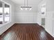 Bright dining room with hardwood flooring, decorative molding and modern lighting at 13820 N Honey Creek Dr, Camby, IN 46113