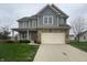Charming two-story home with stone accents, a covered porch, and a well-maintained lawn at 13820 N Honey Creek Dr, Camby, IN 46113