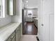 Modern kitchen features stainless steel appliances, an island, and light green cabinetry at 13820 N Honey Creek Dr, Camby, IN 46113
