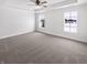 Empty main bedroom with ceiling fan, plush carpet, and bright natural light at 13820 N Honey Creek Dr, Camby, IN 46113