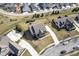 Aerial view of a brick two-story home with a spacious yard and driveway at 13947 Morningtide Cir, Fishers, IN 46038