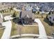 Aerial view of a brick home, nestled in a quiet neighborhood with mature trees and manicured lawns at 13947 Morningtide Cir, Fishers, IN 46038