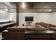 This basement features a dark ceiling, a built in futon area, and a comfy, large, leather couch at 13947 Morningtide Cir, Fishers, IN 46038