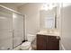 Well-lit bathroom with a walk-in shower featuring a glass door and classic fixtures at 13947 Morningtide Cir, Fishers, IN 46038