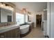 Luxurious bathroom with dual vanities, a standalone tub, and access to a walk-in closet at 13947 Morningtide Cir, Fishers, IN 46038