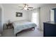 This light-filled bedroom features a ceiling fan, a comfy bed, and a window with natural lighting at 13947 Morningtide Cir, Fishers, IN 46038