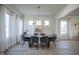 Elegant dining room featuring modern chandelier, large windows, and light hardwood floors at 13947 Morningtide Cir, Fishers, IN 46038