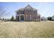 Stately two-story brick home with well-manicured landscaping and a welcoming front entrance at 13947 Morningtide Cir, Fishers, IN 46038