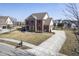 Aerial view of a brick two-story home with a long driveway and manicured lawn at 13947 Morningtide Cir, Fishers, IN 46038