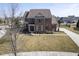 Beautiful brick home with a manicured lawn and garden beds, showcasing classic architectural details at 13947 Morningtide Cir, Fishers, IN 46038