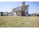 Back exterior of home features a brick chimney and partially covered patio at 13947 Morningtide Cir, Fishers, IN 46038