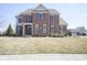 Charming two-story brick home with a well-manicured lawn and classic architectural details at 13947 Morningtide Cir, Fishers, IN 46038