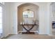 Entryway nook featuring stylish wood table, decorative mirror and neutral wall colors at 13947 Morningtide Cir, Fishers, IN 46038
