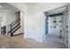 Hallway view of study with french doors and custom shelving near staircase at 13947 Morningtide Cir, Fishers, IN 46038