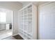 Hallway with ample closet storage space, an entry door, and hardwood floors at 13947 Morningtide Cir, Fishers, IN 46038