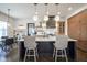 Modern kitchen features an island, stainless appliances, custom cabinets, and pendant lighting at 13947 Morningtide Cir, Fishers, IN 46038
