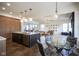 Open-concept kitchen with island, stainless appliances, and adjacent dining and living areas at 13947 Morningtide Cir, Fishers, IN 46038